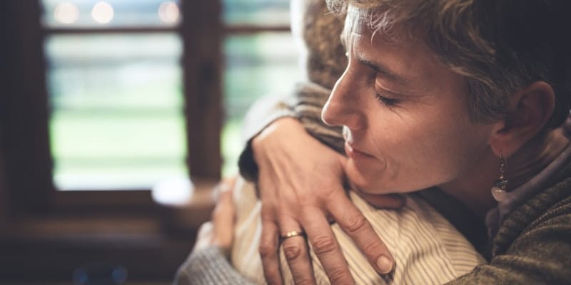 Senior couple embrace in kitchen i stock 498746836